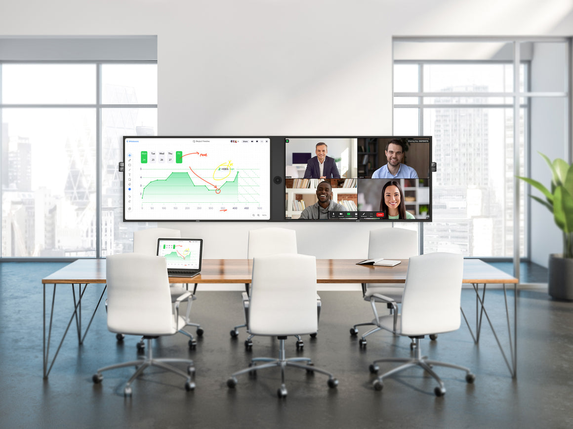 Modern conference room with a large screen displaying a video call with four participants.