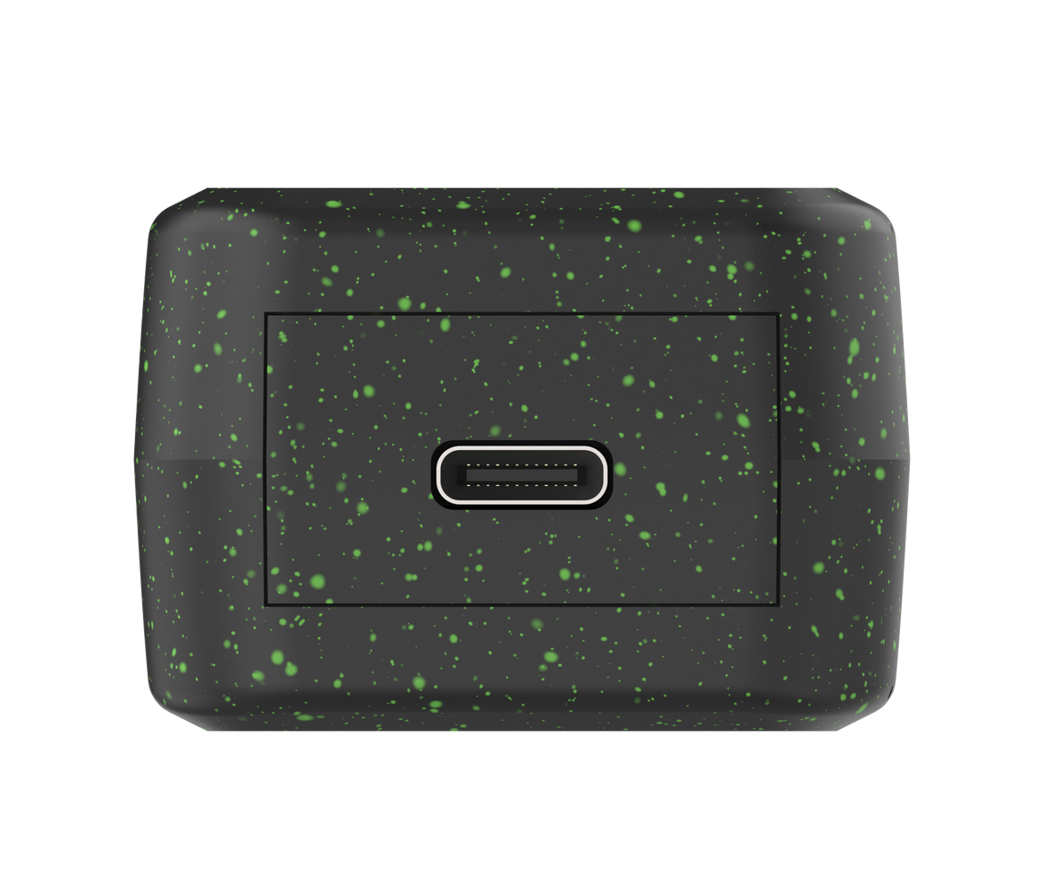 Black rectangular object with green speckles on a white background