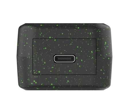 Black rectangular object with green speckles on a white background