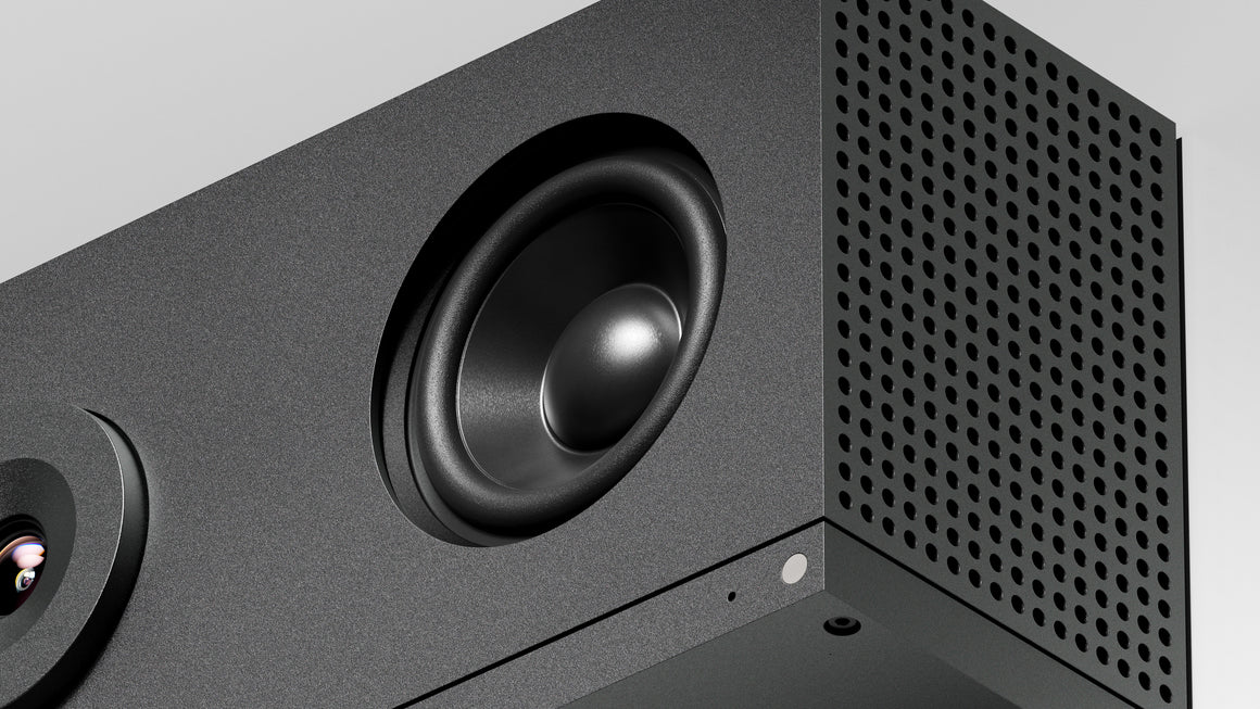 Close-up of a black speaker with a detailed view of the cone and grille.