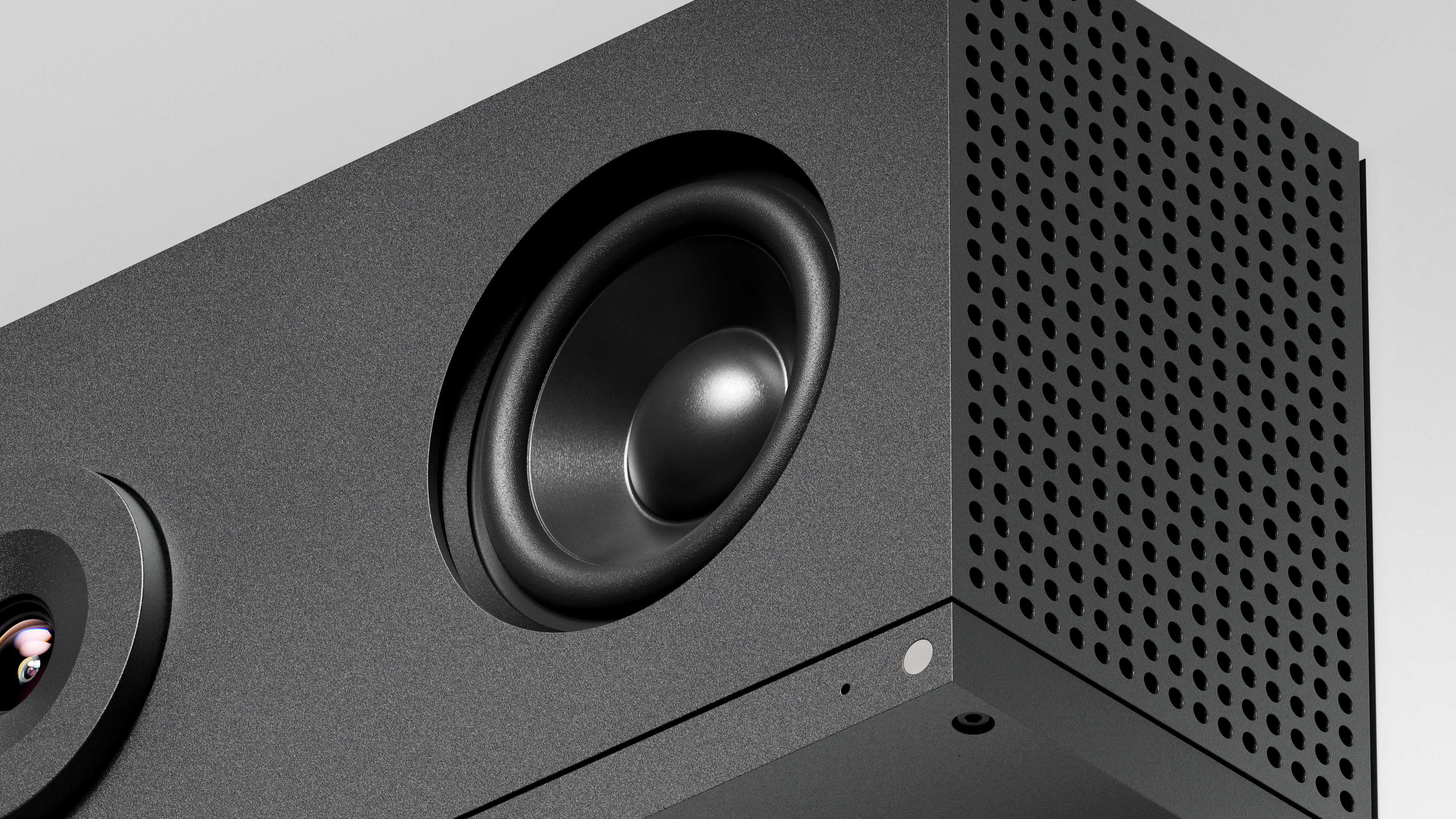 Close-up of a black speaker with a detailed view of the cone and grille.